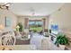 Bright living room featuring neutral décor, tile flooring, and outdoor views at 9641 Castle Point Dr # 1215, Sarasota, FL 34238