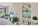 Bright living room with tile flooring, shelving unit, and decorative mirrored display at 9641 Castle Point Dr # 1215, Sarasota, FL 34238