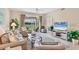 Bright living room with comfortable seating and a view to the lanai at 9641 Castle Point Dr # 1215, Sarasota, FL 34238