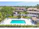 Community pool with lounge chairs and tables provides a relaxing outdoor space in this community at 9641 Castle Point Dr # 1215, Sarasota, FL 34238