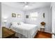 Cozy bedroom featuring natural light, a ceiling fan, and hardwood floors, creating a comfortable and serene space at 1108 65Th W Ave, Bradenton, FL 34207