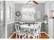 Bright dining area showcasing a round table with seating for four, complemented by stylish decor and natural light at 1108 65Th W Ave, Bradenton, FL 34207