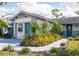 Charming single-story home with lush landscaping, walkway, and vibrant blue accent door at 1108 65Th W Ave, Bradenton, FL 34207