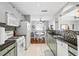 Well-lit kitchen featuring a breakfast bar that leads to a dining area, complete with modern appliances at 1108 65Th W Ave, Bradenton, FL 34207