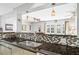 Modern kitchen with granite counters, mosaic backsplash, and open view to the living area at 1108 65Th W Ave, Bradenton, FL 34207