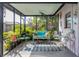 Relaxing screened-in patio area with cozy seating and lush greenery, perfect for outdoor enjoyment at 1108 65Th W Ave, Bradenton, FL 34207