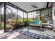 Relaxing screened porch with comfortable seating and lush surrounding greenery at 1108 65Th W Ave, Bradenton, FL 34207
