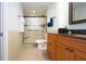 Bathroom featuring a glass-enclosed shower, wood vanity, and tile flooring at 1255 E Peppertree Dr # 506, Sarasota, FL 34242