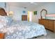 Bedroom features wicker furniture, a television and a glimpse into the bathroom at 1255 E Peppertree Dr # 506, Sarasota, FL 34242