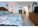 Bedroom with wicker furniture, white walls, and a glimpse into the ensuite bathroom at 1255 E Peppertree Dr # 506, Sarasota, FL 34242