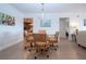 Cozy dining area with a glass table and woven chairs leading to an open kitchen at 1255 E Peppertree Dr # 506, Sarasota, FL 34242
