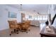Bright dining area with woven chairs, opening into a spacious living room with water views at 1255 E Peppertree Dr # 506, Sarasota, FL 34242