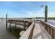 Community dock with railings overlooking the ocean and waterfront homes at 1255 E Peppertree Dr # 506, Sarasota, FL 34242