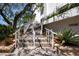 Exterior view showcasing the inviting stairs with railings, leading to a well-maintained condominium entrance at 1255 E Peppertree Dr # 506, Sarasota, FL 34242