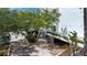Condominium building featuring lush landscaping, convenient parking, an inviting entrance with stairs, and garage at 1255 E Peppertree Dr # 506, Sarasota, FL 34242