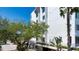Exterior view of condominium building with lush landscaping, an inviting entrance with stairs and convenient parking at 1255 E Peppertree Dr # 506, Sarasota, FL 34242