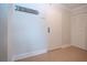 Neutral hallway with tile flooring, white door, and decorative 'Sunbathing' sign at 1255 E Peppertree Dr # 506, Sarasota, FL 34242