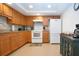 Bright kitchen with stainless steel appliances, wooden cabinets, and granite countertops at 1255 E Peppertree Dr # 506, Sarasota, FL 34242