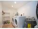 Functional laundry area with washer, dryer, and hot water heater for convenience at 1255 E Peppertree Dr # 506, Sarasota, FL 34242