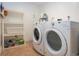 Practical laundry room featuring a white washer and dryer and ample storage space at 1255 E Peppertree Dr # 506, Sarasota, FL 34242