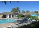 Community pool area with lounge chairs, umbrellas, and well-maintained landscaping at 1255 E Peppertree Dr # 506, Sarasota, FL 34242