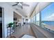 Bright sun room features large windows with water views and cozy seating at 1255 E Peppertree Dr # 506, Sarasota, FL 34242