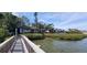 Wooden walkway next to water, mangroves and condominium complex at 1255 E Peppertree Dr # 506, Sarasota, FL 34242