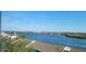 Stunning intercoastal view from window overlooking water, lush greenery, and beautiful coastline. Enjoy waterfront living at 1255 E Peppertree Dr # 506, Sarasota, FL 34242