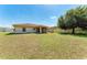 Spacious backyard featuring a well-maintained lawn and a screened-in lanai at 1323 Arredondo St, North Port, FL 34286