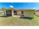 A view of the backyard with screened-in lanai and a storage shed at 1323 Arredondo St, North Port, FL 34286