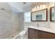 Bright bathroom featuring a tiled shower and modern vanity at 1323 Arredondo St, North Port, FL 34286