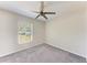 Neutral bedroom with a modern ceiling fan and a view to the outdoors at 1323 Arredondo St, North Port, FL 34286