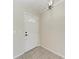 Bright entry foyer showcasing neutral paint and tile flooring, illuminated by a modern light fixture at 1323 Arredondo St, North Port, FL 34286