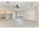 Expansive living area featuring tile floors, modern lighting, and a large window overlooking lush greenery at 1323 Arredondo St, North Port, FL 34286