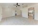 Spacious living room featuring tile flooring, neutral walls, and ceiling fan providing a cozy atmosphere at 1323 Arredondo St, North Port, FL 34286