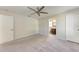Spacious main bedroom featuring a ceiling fan, carpet flooring, and an en-suite bathroom at 1323 Arredondo St, North Port, FL 34286