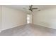Spacious main bedroom featuring a ceiling fan, carpet flooring, and an en-suite bathroom at 1323 Arredondo St, North Port, FL 34286