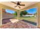Screened in patio with brick flooring, ceiling fan and view to the backyard at 1323 Arredondo St, North Port, FL 34286