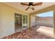 View of the brick paved screened lanai with ceiling fan and access to the living room at 1323 Arredondo St, North Port, FL 34286