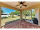 Enjoy outdoor living in this screened patio with brick pavers and a ceiling fan at 1323 Arredondo St, North Port, FL 34286