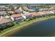An aerial view of lakefront homes featuring private pools and lush landscaping at 13409 Ramblewood Trl, Bradenton, FL 34211