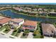 Beautiful community with lake, lush greenery, and homes featuring red tile roofs and well-maintained landscaping at 13409 Ramblewood Trl, Bradenton, FL 34211