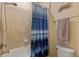 Bathroom featuring a shower with tiled walls and a blue striped shower curtain at 13409 Ramblewood Trl, Bradenton, FL 34211