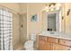 Bright bathroom featuring a shower, toilet, and vanity with a mirror and lighting at 13409 Ramblewood Trl, Bradenton, FL 34211