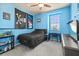 Bedroom featuring blue walls, dark carpet, ceiling fan, and black furniture at 13409 Ramblewood Trl, Bradenton, FL 34211