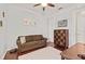 Bedroom featuring hardwood floors, a comfortable sofa, and a mid-century modern dresser at 13409 Ramblewood Trl, Bradenton, FL 34211