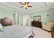 View of the bedroom showing the dresser with mirror, chair and open door leading to stairs at 13409 Ramblewood Trl, Bradenton, FL 34211