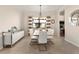 Elegant dining room features modern white furniture, stylish lighting, and a mirrored buffet for sophisticated gatherings at 13409 Ramblewood Trl, Bradenton, FL 34211