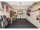 Spacious garage featuring overhead storage racks, a workbench, and black tiled flooring at 13409 Ramblewood Trl, Bradenton, FL 34211