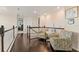 Hallway with dark hardwood floors and two armchairs at 13409 Ramblewood Trl, Bradenton, FL 34211